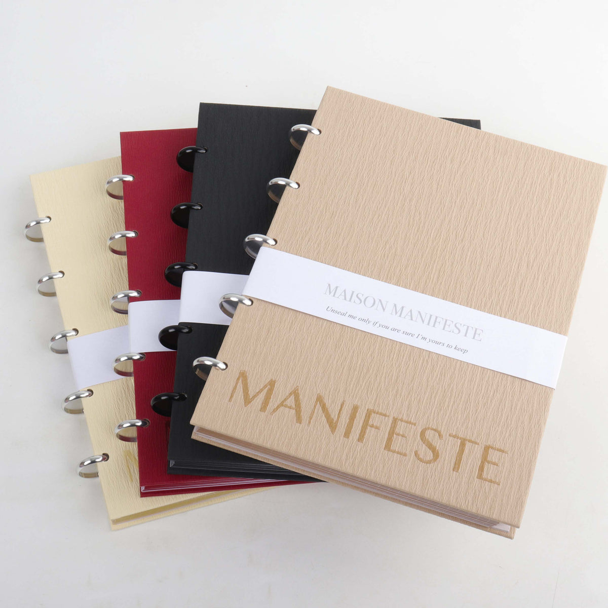 Set of Maison Manifeste notebooks in Burgundy, Chai, Buttercream, and Black