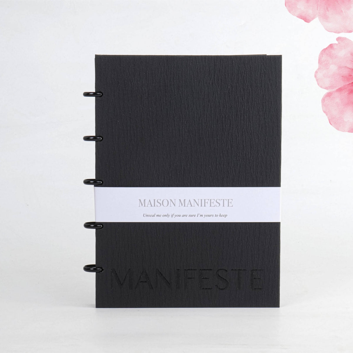 Black A4 (8.27 x 11.69 in) discbound notebook front cover: belly band, embossed MANIFESTE wordmark